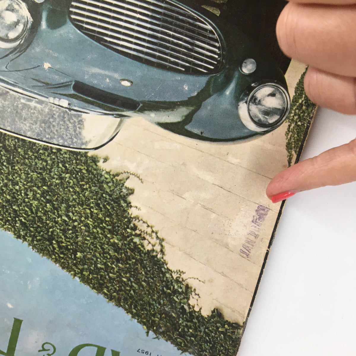 Close-up view of VTG Road & Track Magazine February 1957 showing the cover detail and a stamped date mark, highlighting the classic Salon Car Model 'A' Ford.