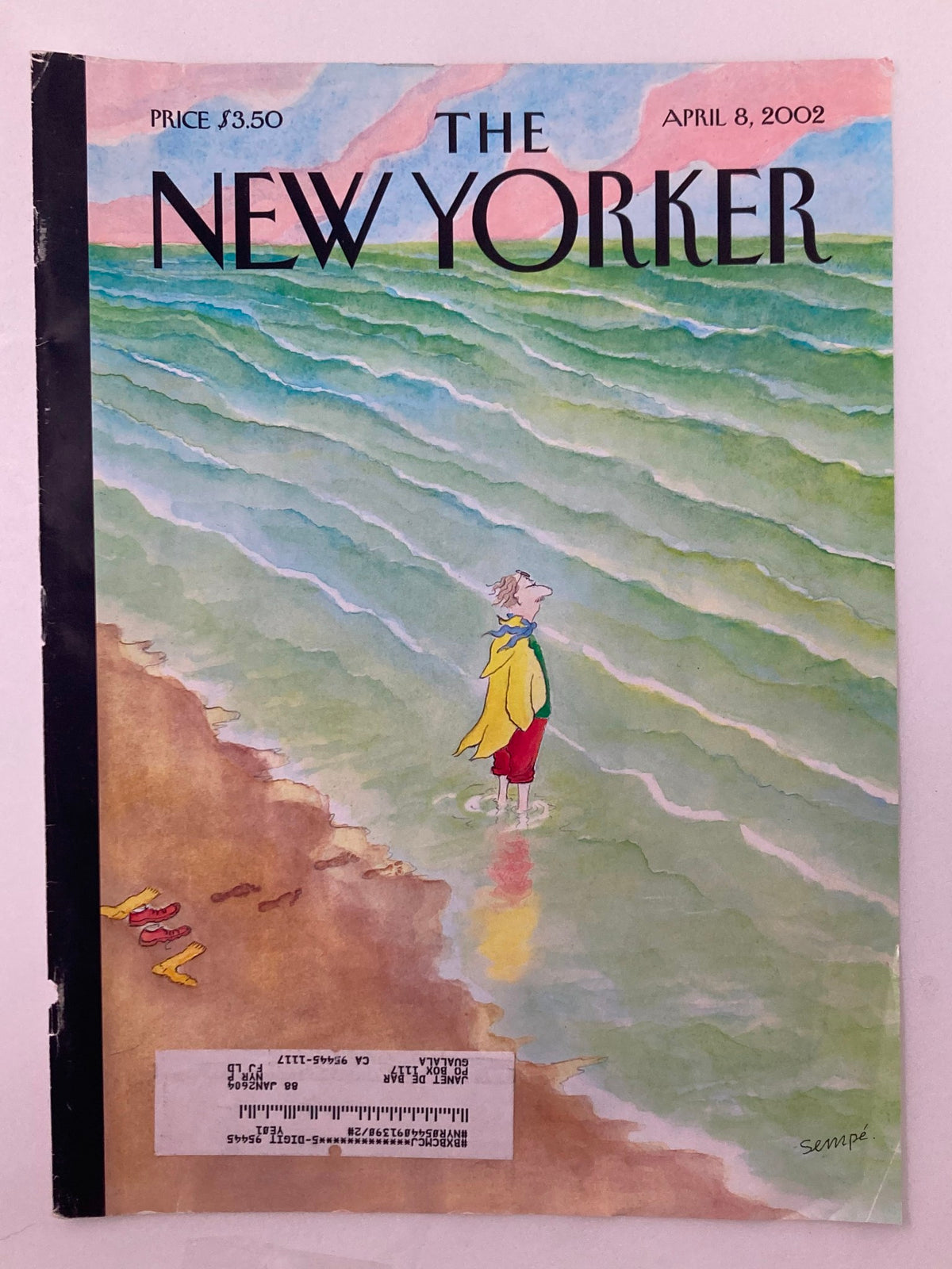 The New Yorker Cover April 8 2002 by Jean-Jacques Sempé, depicting a colorful beach scene with a character in a yellow coat gazing at the ocean.
