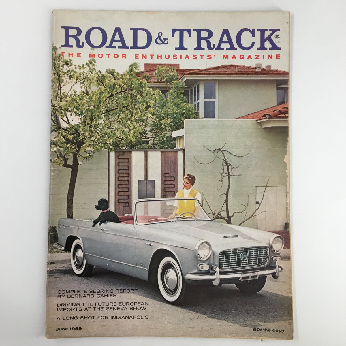 Cover of VTG Road & Track Magazine June 1959 featuring a vintage convertible car and a woman in a yellow top, highlighting the article 'A Long Shot for Indianapolis'.
