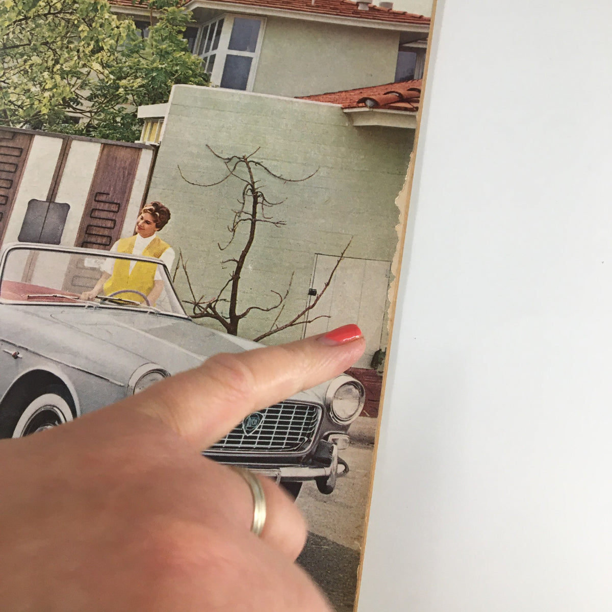Close-up of the VTG Road & Track Magazine June 1959 cover, focusing on the vintage car and a woman pointing, showcasing the magazine's nostalgic automotive theme.