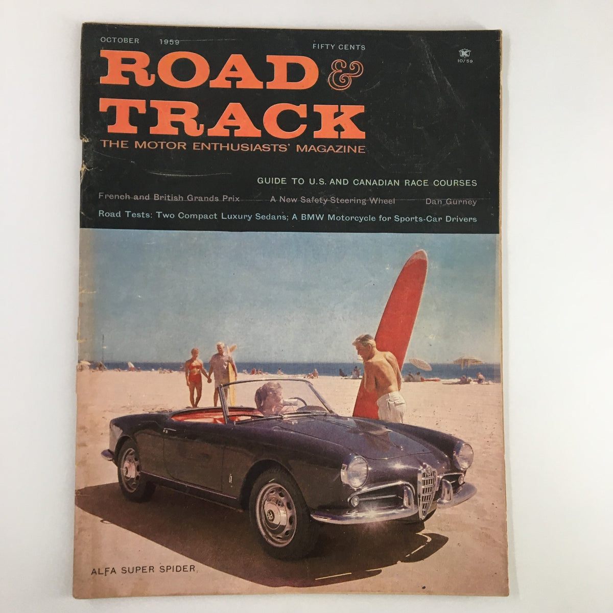 Cover of VTG Road & Track Magazine October 1959 featuring an Alfa Super Spider on the beach, showcasing two compact luxury sedans test.