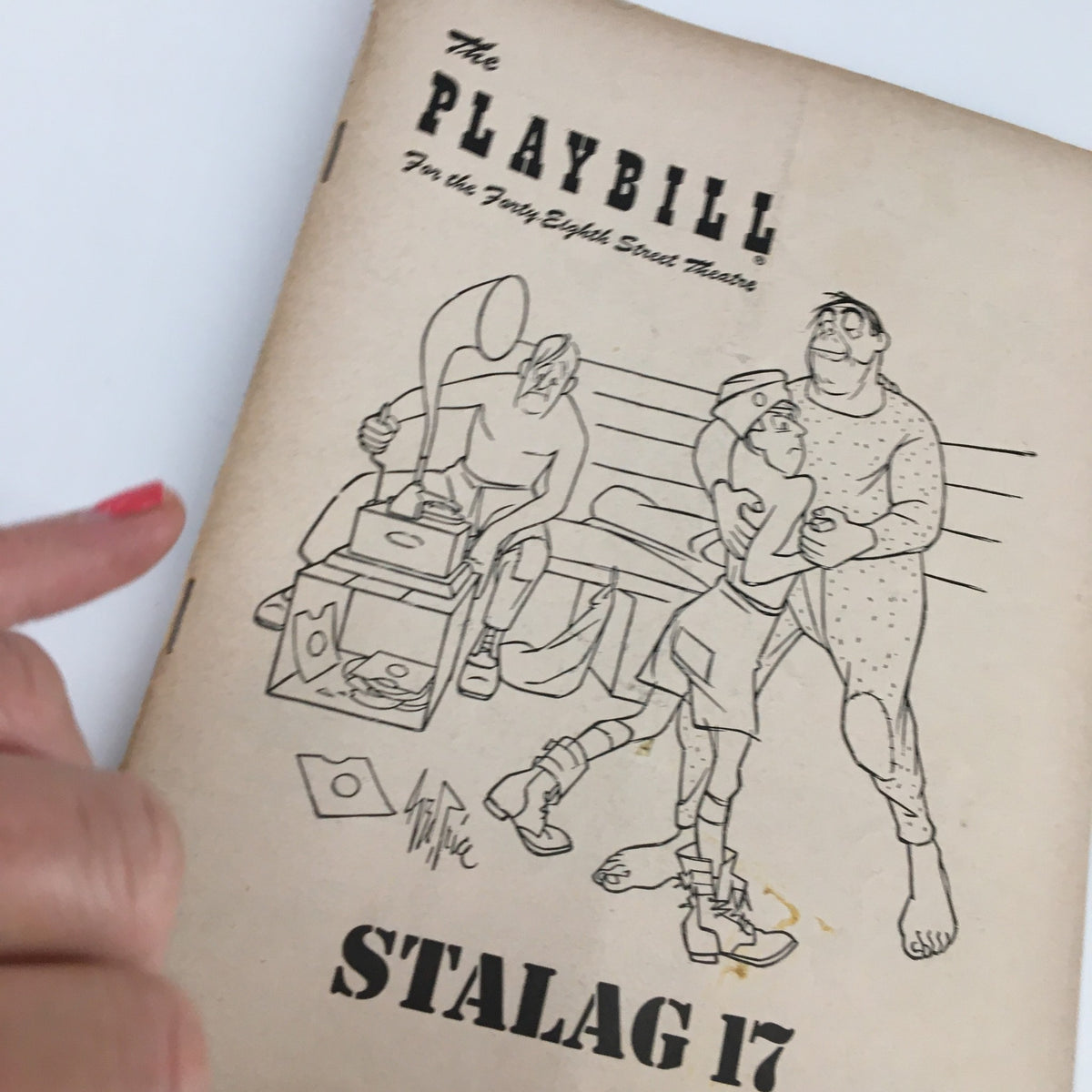 Close-up view of the 1951 Playbill for 'Stalag 17' at the Forty-Eighth Street Theatre, highlighting the illustrative cover details.