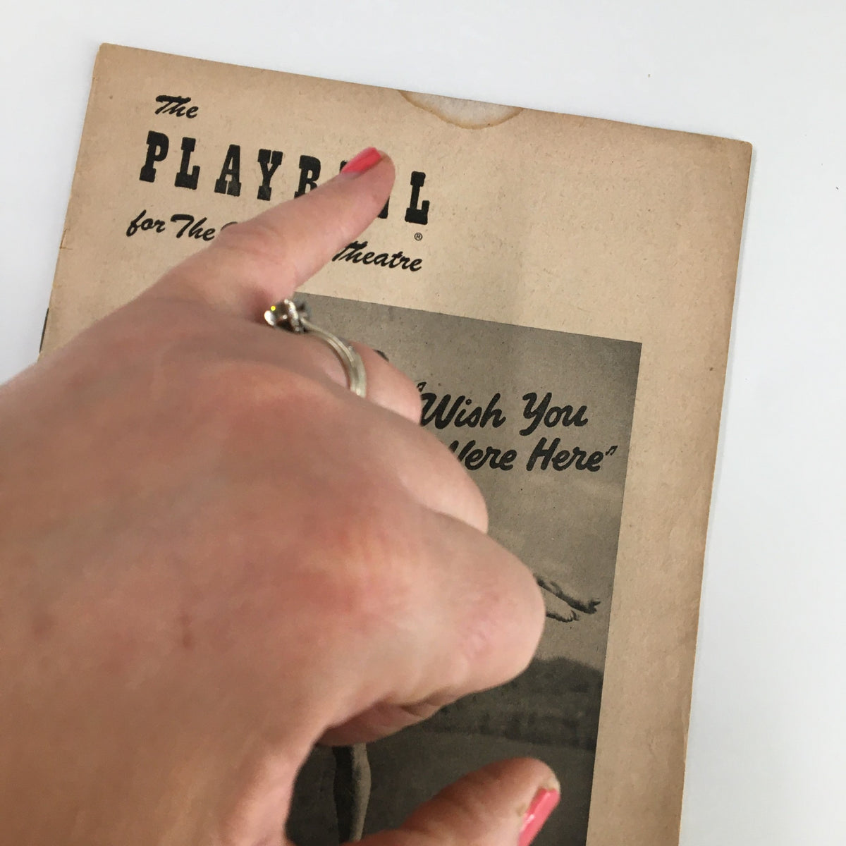Hand holding the 1952 Playbill for 'Wish You Were Here' at the Imperial Theatre, showcasing its vintage cover.
