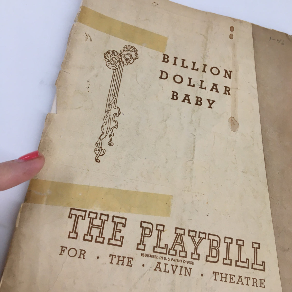 Close-up of the 1946 Playbill for 'Billion Dollar Baby' at the Alvin Theatre, showcasing its aged appearance with tape and marks, perfect for collectors.