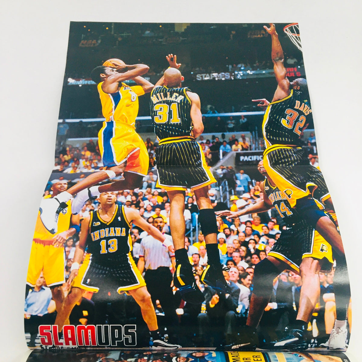 Poster included in Slam Magazine September 2000 #45, depicting a dynamic moment in basketball featuring multiple players in action during an intense game scene.