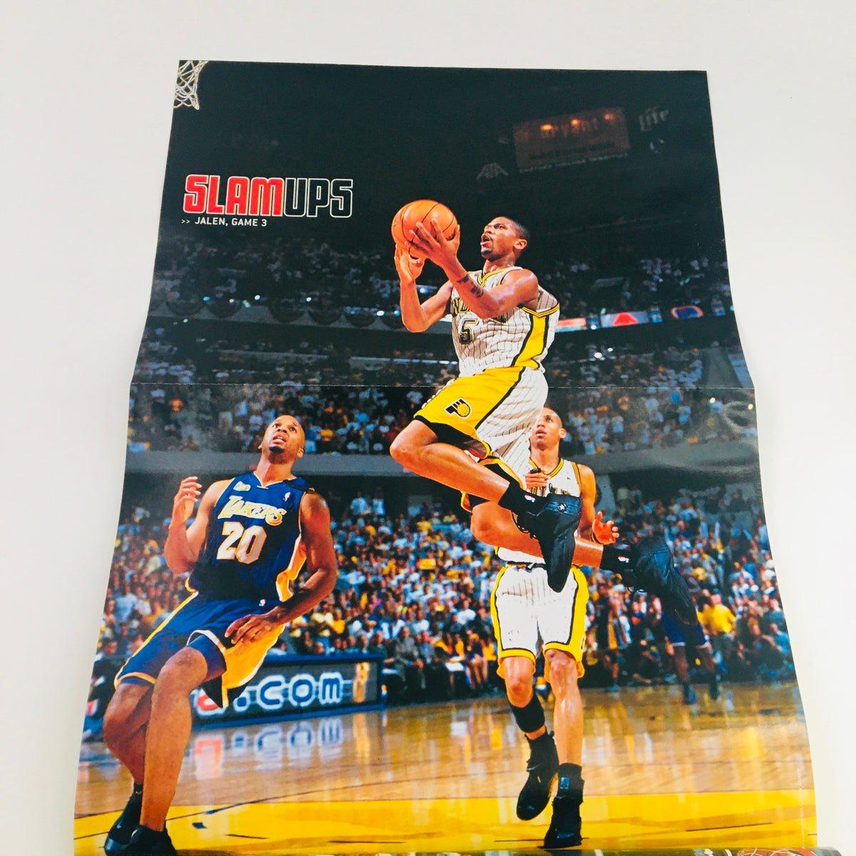 Another poster from Slam Magazine September 2000 #45 showcasing an exciting jump shot by an NBA player during a game, highlighting the fast-paced nature of basketball.