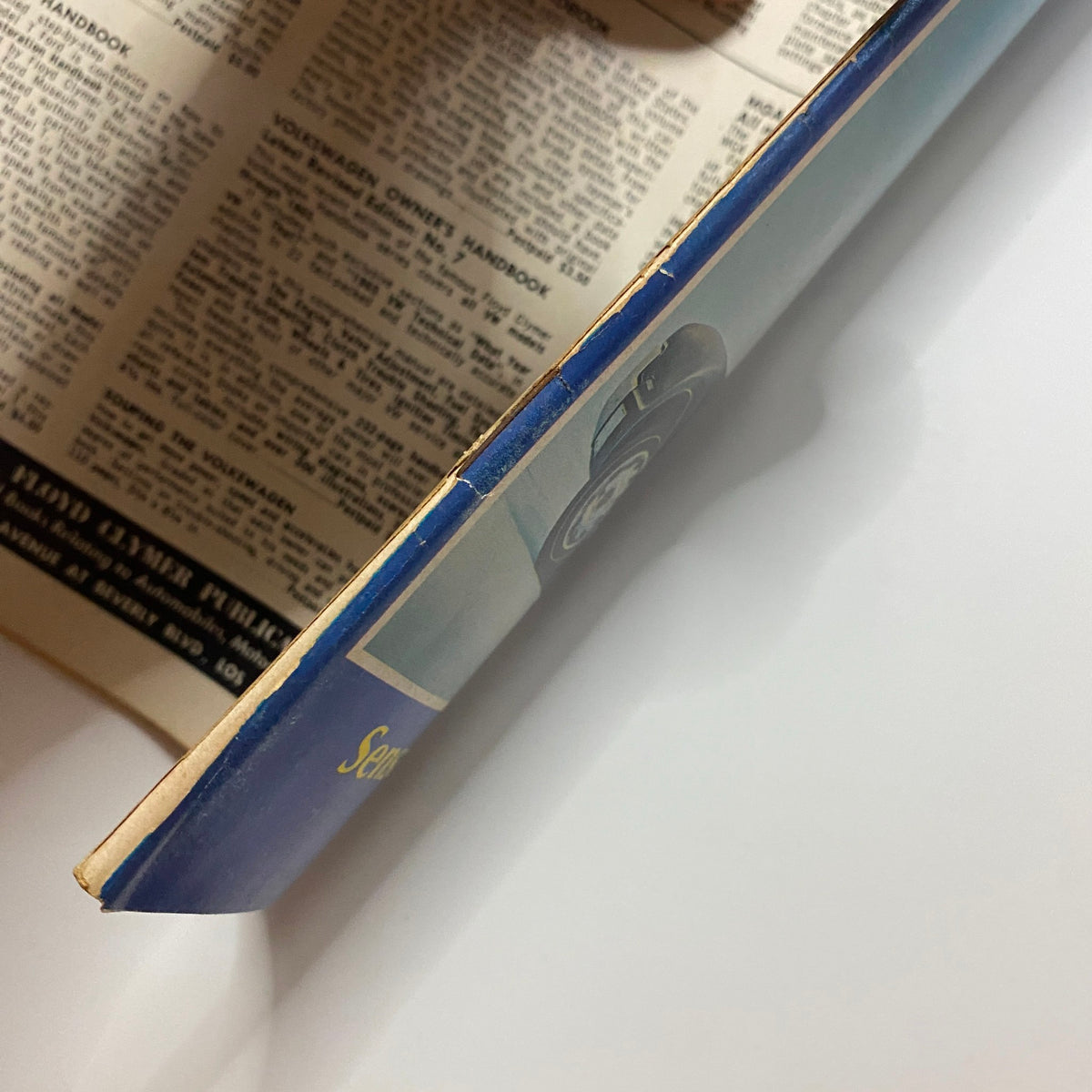 Side view of VTG Auto Topics Magazine December 1965 New Oldsmobile Toronado showcasing the spine and edge, highlighting vintage book design.