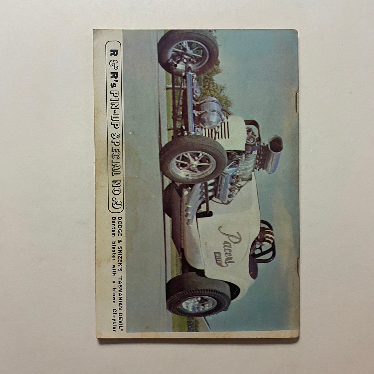 Back cover of VTG Rodding & Re-Styling Magazine August 1963 showcasing a pin-up special with a classic car image.