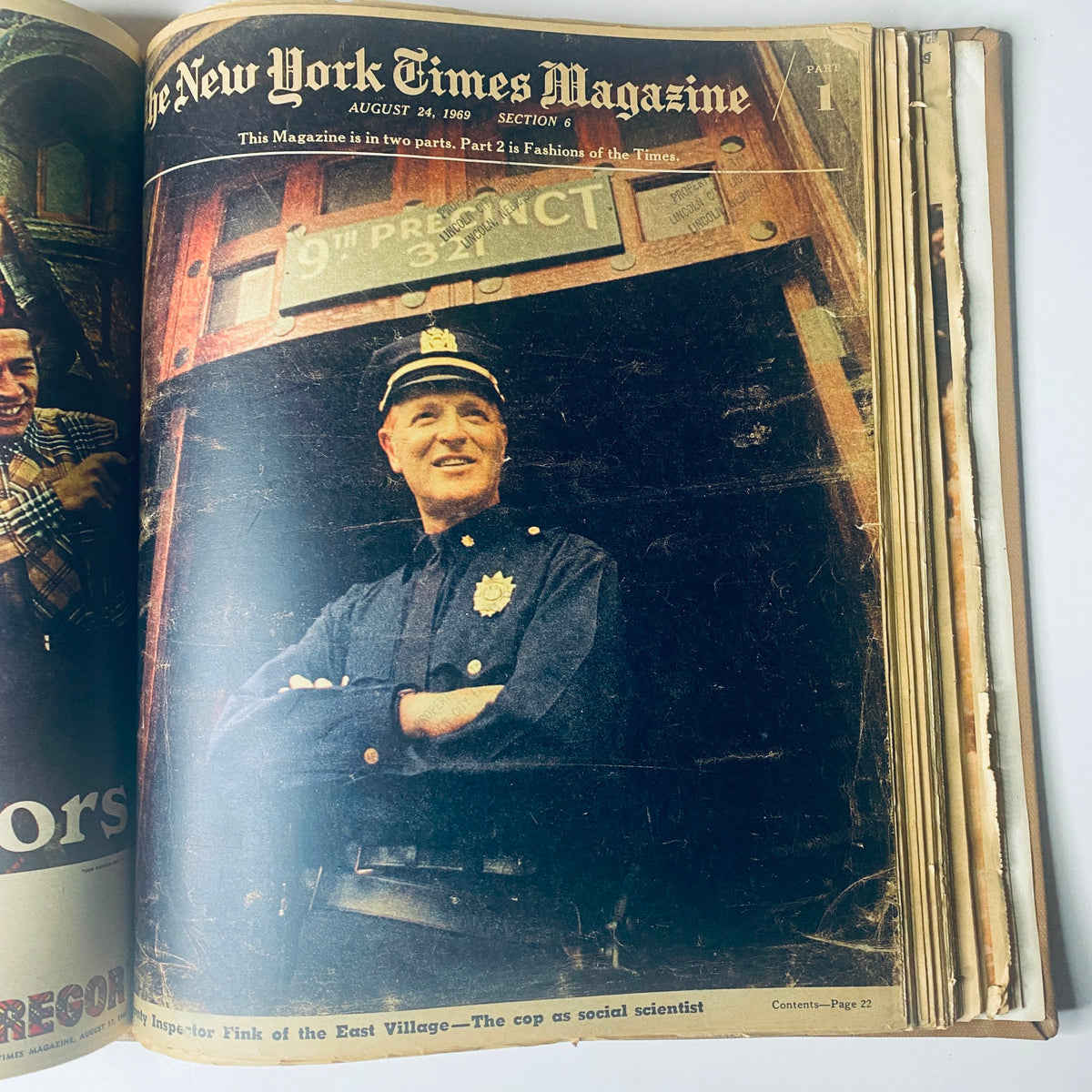Cover of The New York Times Magazine, August 24, 1969, depicting a police officer smiling in front of a precinct sign, exploring themes around urban policing and community.