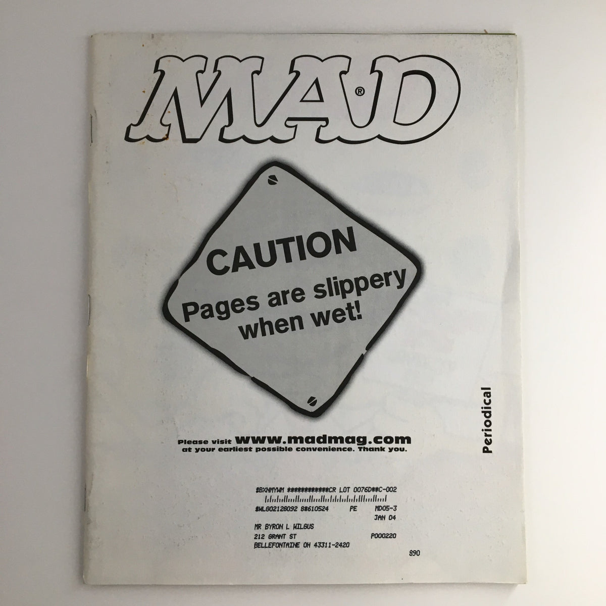 Back cover of Mad Magazine May 2003 #429, featuring a warning sign stating 'Caution: Pages are slippery when wet,' highlighting the magazine's playful nature.