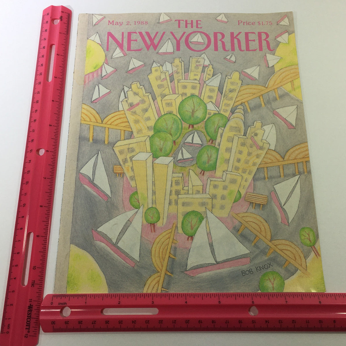 Cover of The New Yorker Magazine May 2, 1988 shown with a ruler for size comparison, featuring artistic design by Bob Knox of a lively urban scene with sailboats.