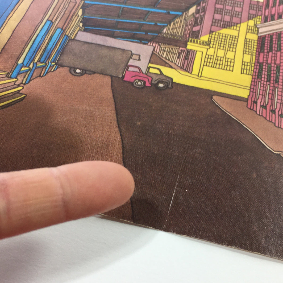Close-up detail of the cover art from The New Yorker Magazine June 20 1983, showcasing Roxie Munro's artistic style with a focus on a street scene featuring trucks and buildings.