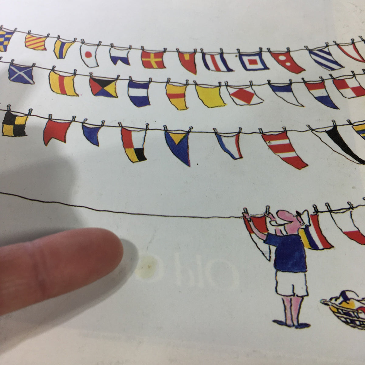 Close-up of the The New Yorker Magazine June 3, 1985 cover, highlighting colorful flags and a character adjusting the laundry.