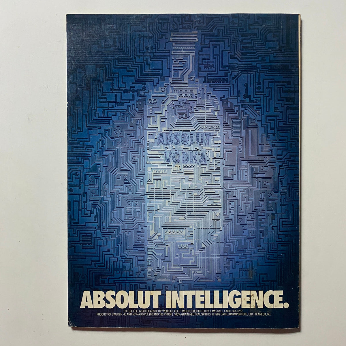 Back cover of Omni Magazine May 1991 featuring a stylized minimalist design with the text 'ABSOLUT INTELLIGENCE' and an abstract background that resembles a circuit board pattern, promoting Absolut Vodka.