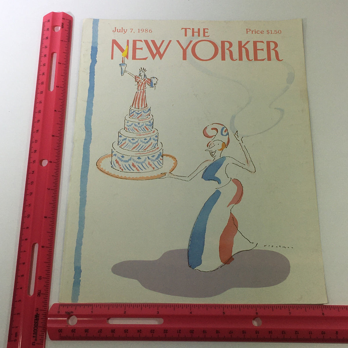 The New Yorker Magazine cover dated July 7, 1986, displayed with a ruler for size reference, illustrating a woman presenting a festive cake.