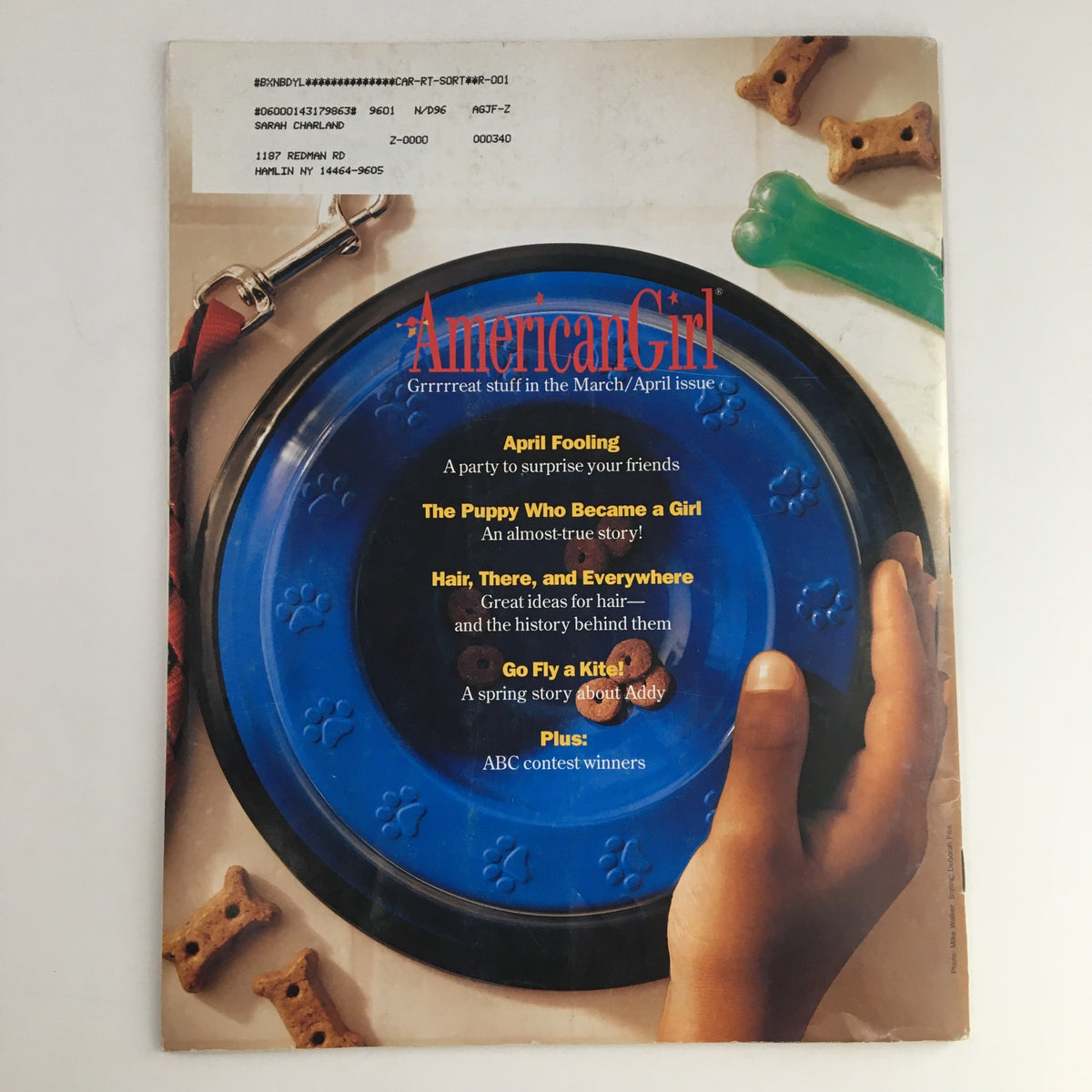 Back cover of the American Girl Magazine January 1996 featuring a blue dog bowl and highlighting articles within, including a story about Addy.
