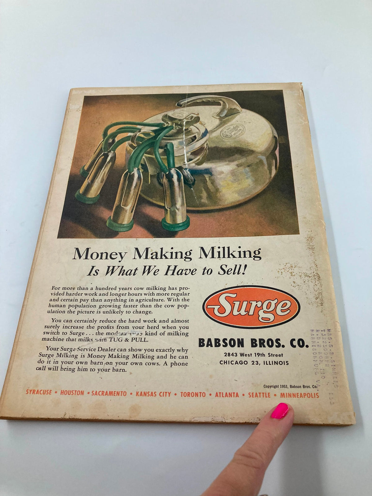 Back cover of Farm Journal Magazine May 1953 featuring an advertisement by Babson Bros. Co. for milking equipment, highlighting historical agricultural practices.