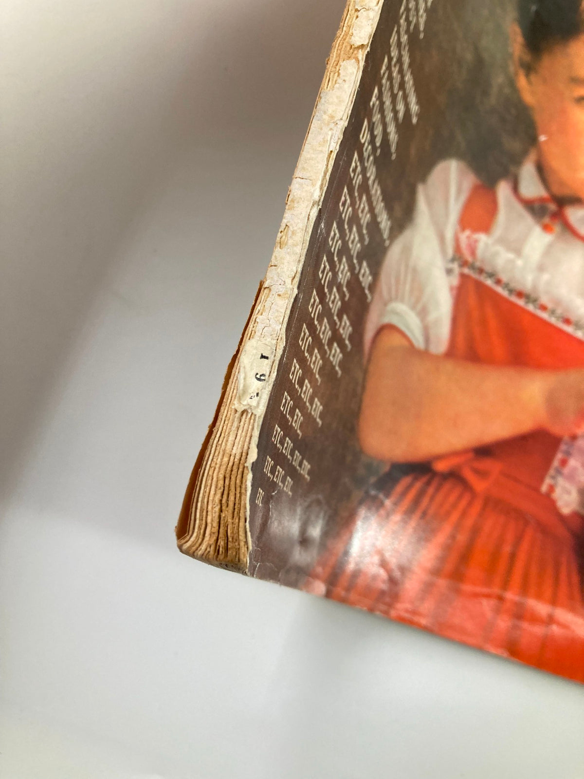 Side view of the VTG McCall's Magazine December 1959 showing worn edges and spine, capturing its vintage character and charm.