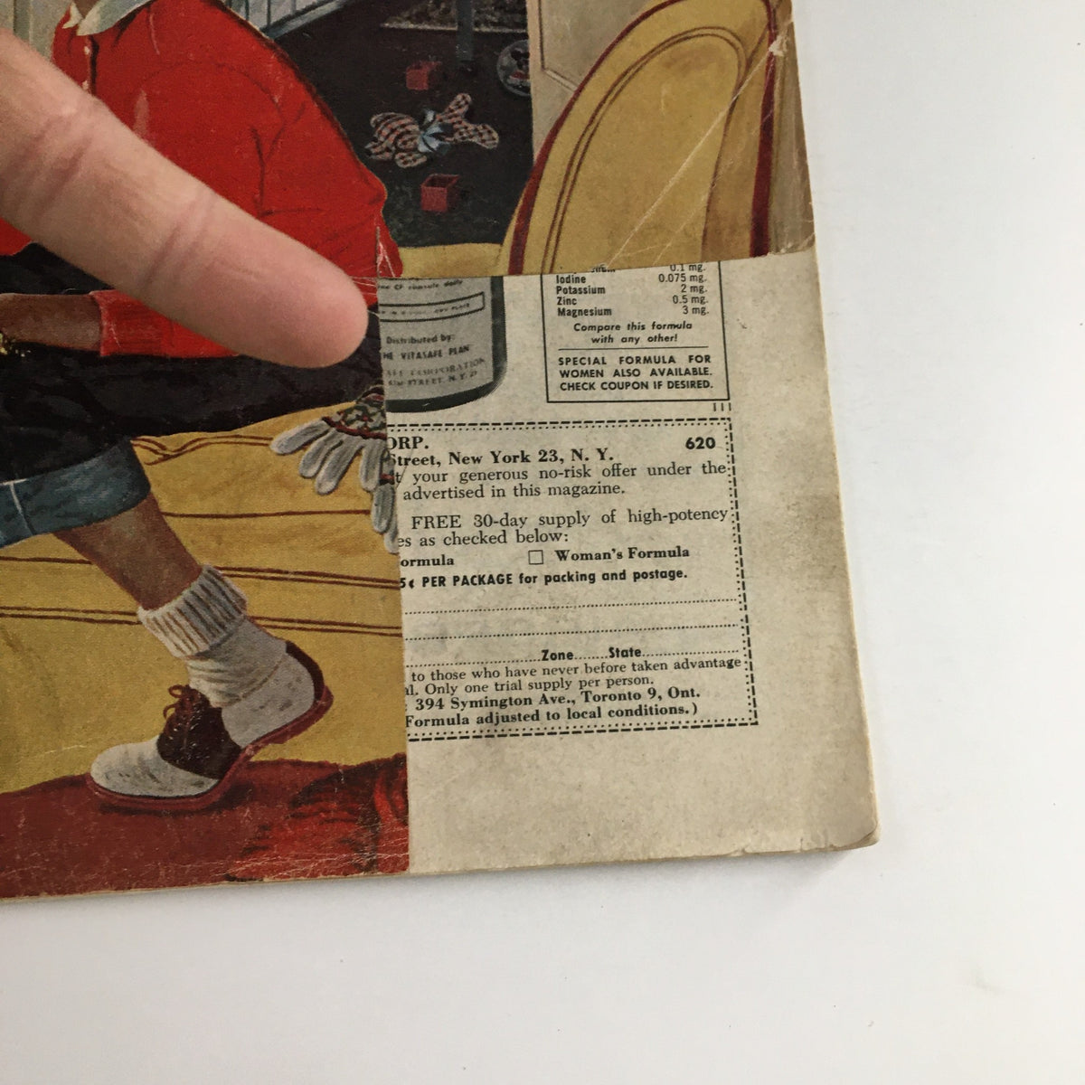 Close-up of the cover of The Saturday Evening Post January 4, 1958, showcasing additional details including an advertisement on the lower portion and the young man in a red sweater.