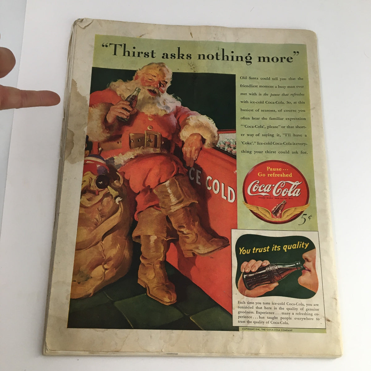 The back cover advertisement of The Saturday Evening Post dated December 13, 1941, featuring Santa Claus enjoying a Coca-Cola, promoting the drink with vintage charm and nostalgic appeal.