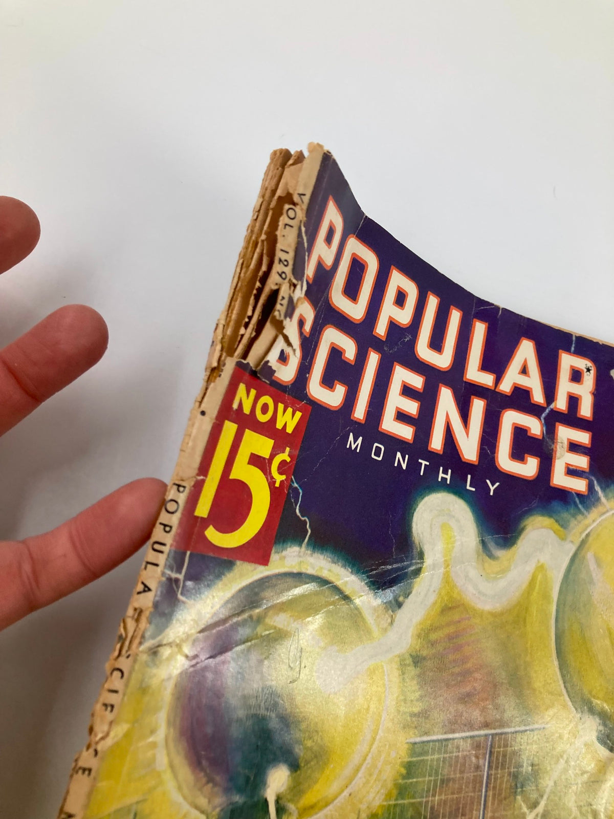 Close-up view of the spine of VTG Popular Science Magazine November 1936 showing the wear consistent with age, highlighting its vintage quality and character.