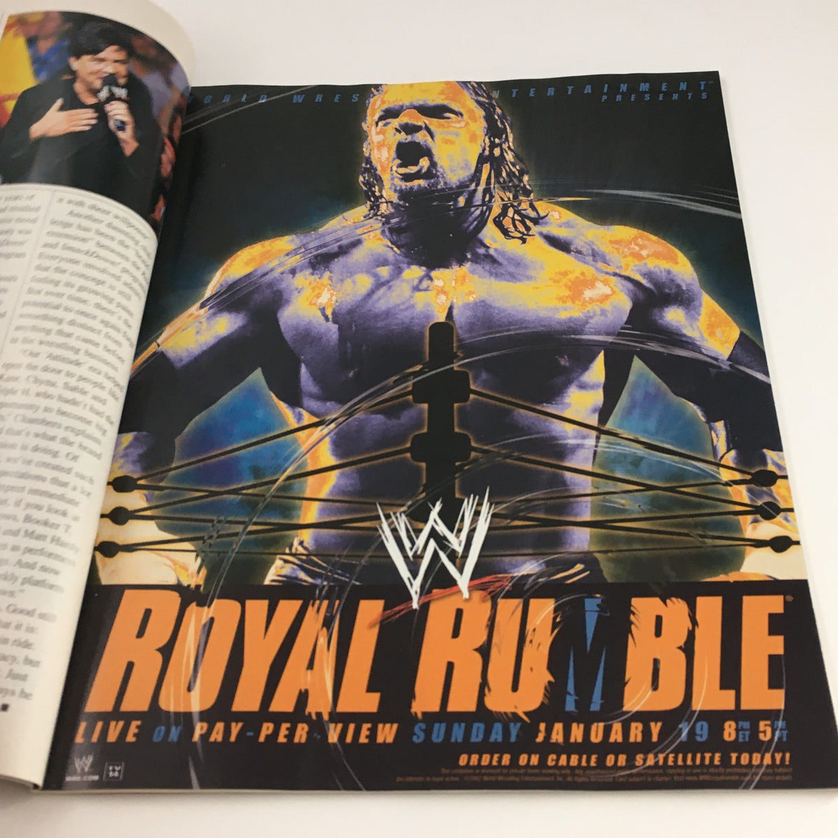 WWE Raw Magazine Holiday 2002 advertisement for Royal Rumble, highlighting the event happening on January 19th, featuring vibrant artwork of a wrestling superstar.