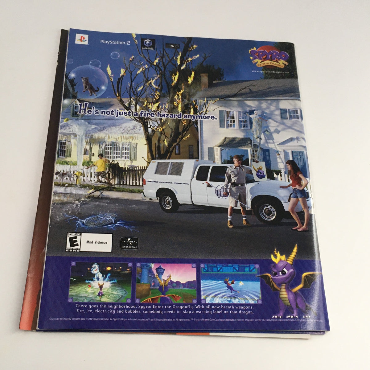 WWE Raw Magazine December 2002 cover showing the back with a promotional image for the video game Spyro, featuring vibrant graphics and action scenes.