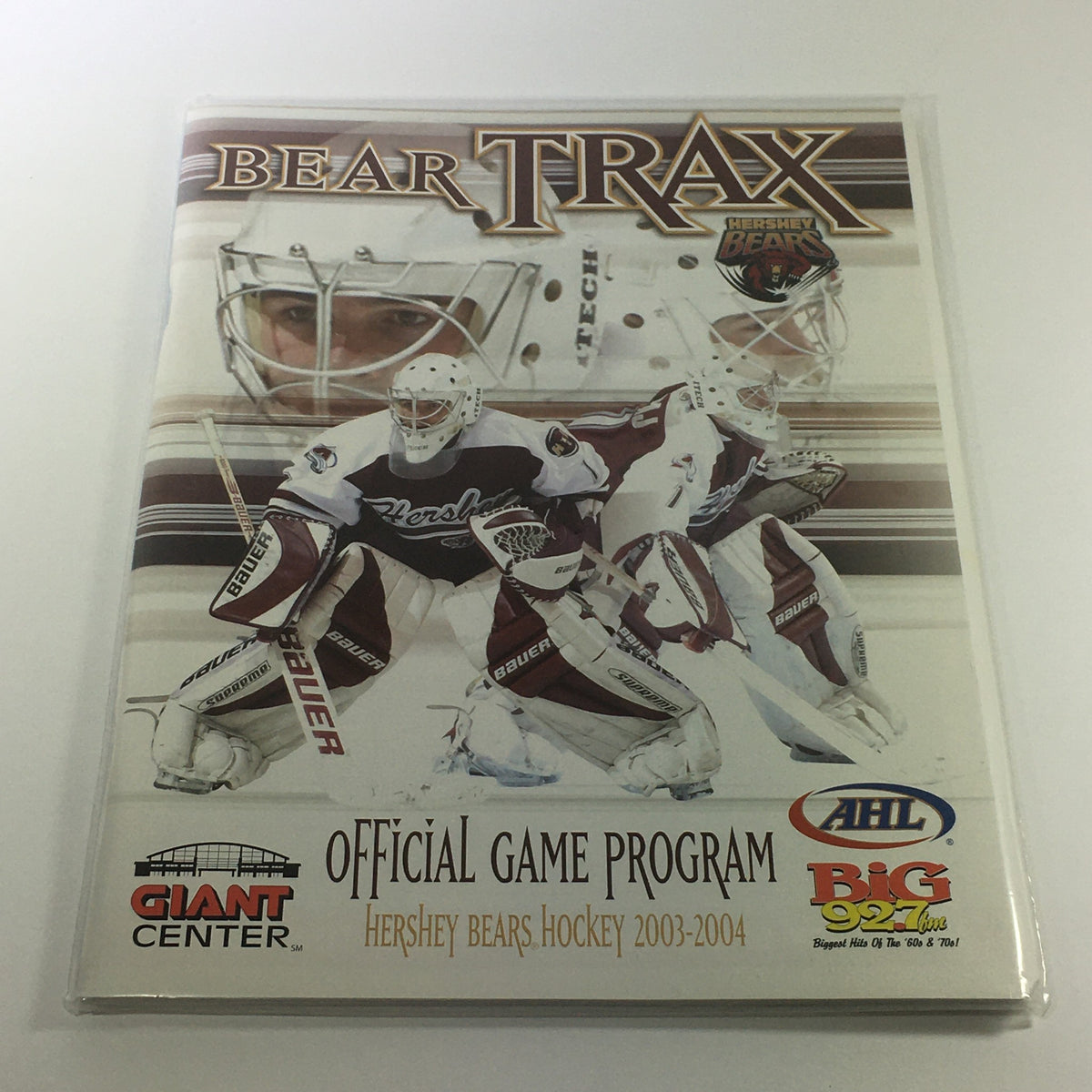 Hershey Bear Trax Official Game Program 2003-2004 featuring hockey players and goalie on the cover, in excellent condition and bagged for protection.