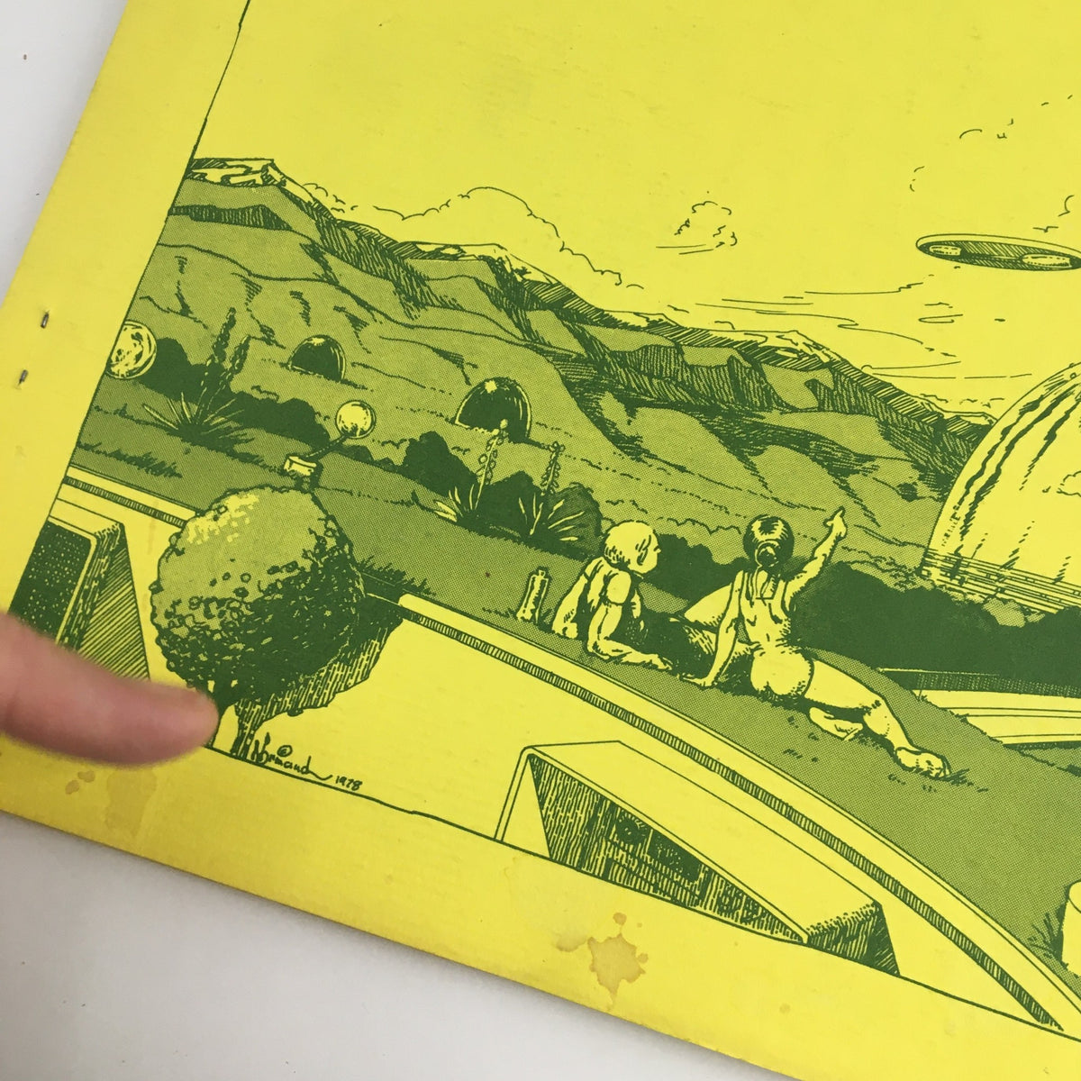 Close-up of the cover illustration of Den Visions Vol 1 No. 1, 1978, showcasing a futuristic scene with figures and a flying saucer.