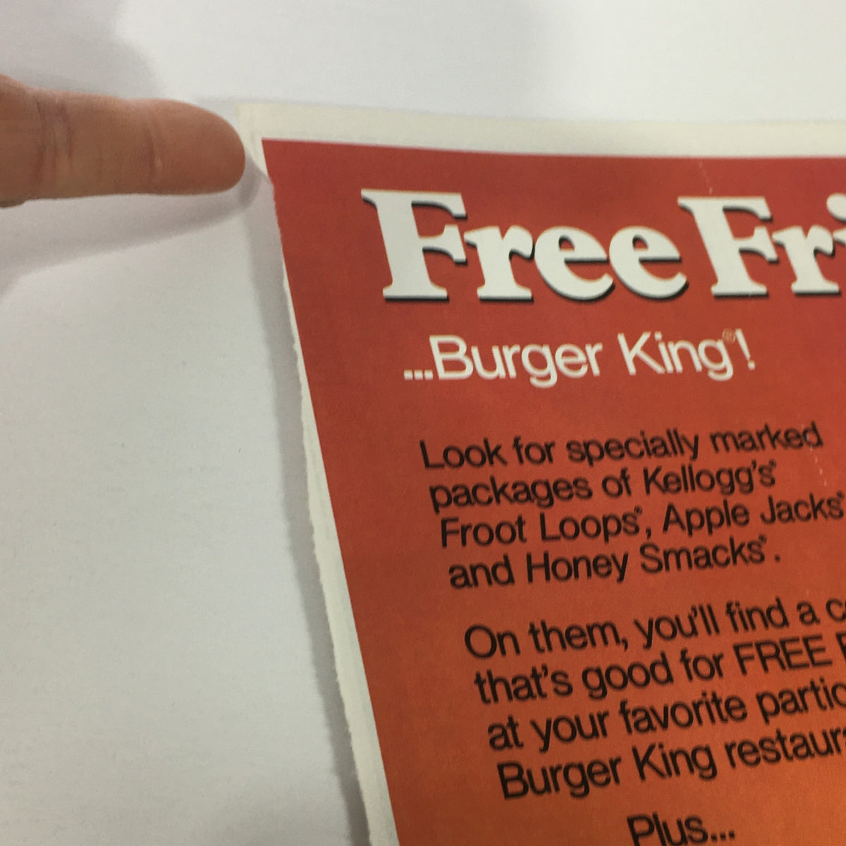 Vintage advertisement for Kellogg's cereals offering free Burger King fries, featuring details on participating cereal packages, dated 1984.