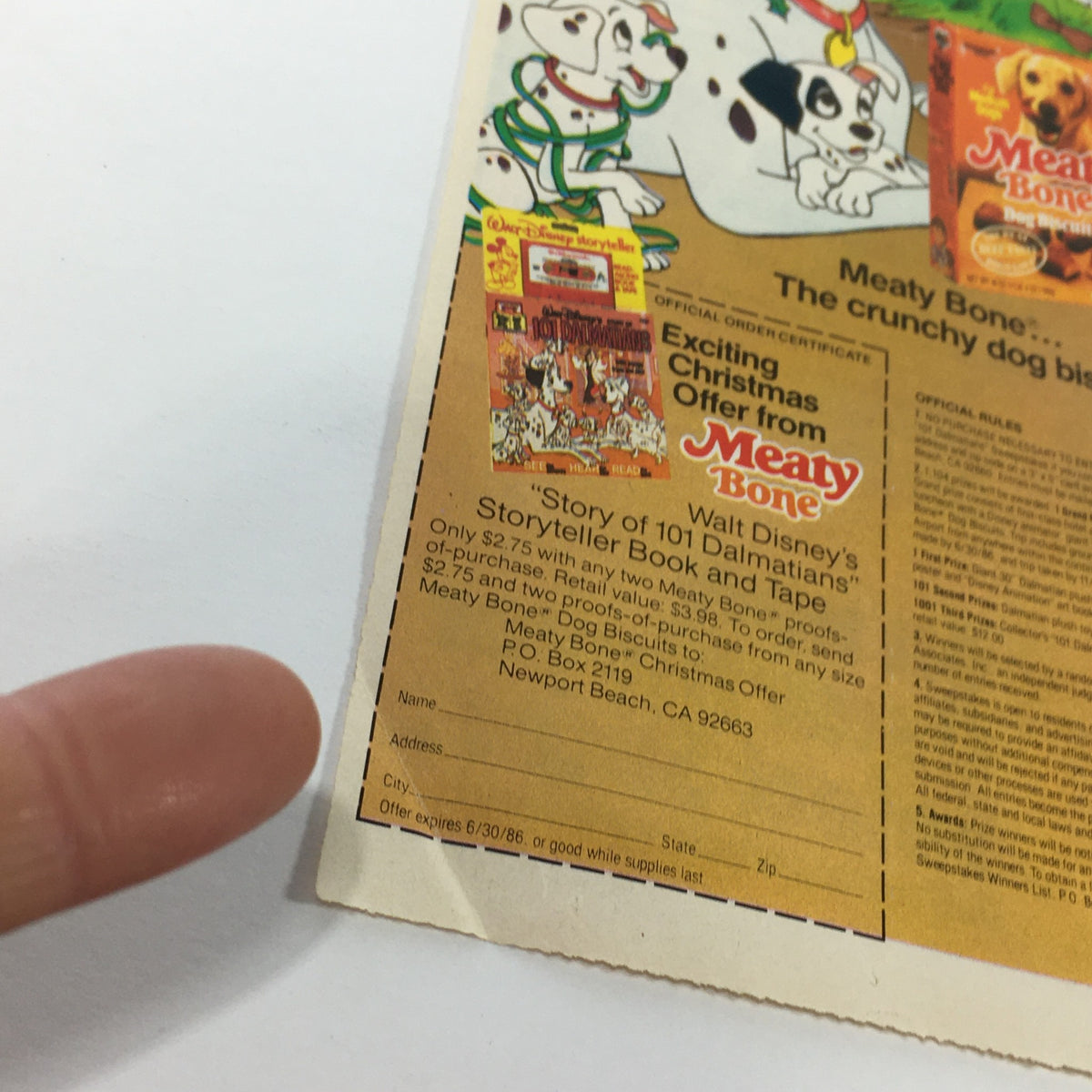Close-up of the vintage Meaty Bone Dog Biscuits coupon advertisement showing the promotion for Disney's Storyteller Book and Tape, dated 1986.