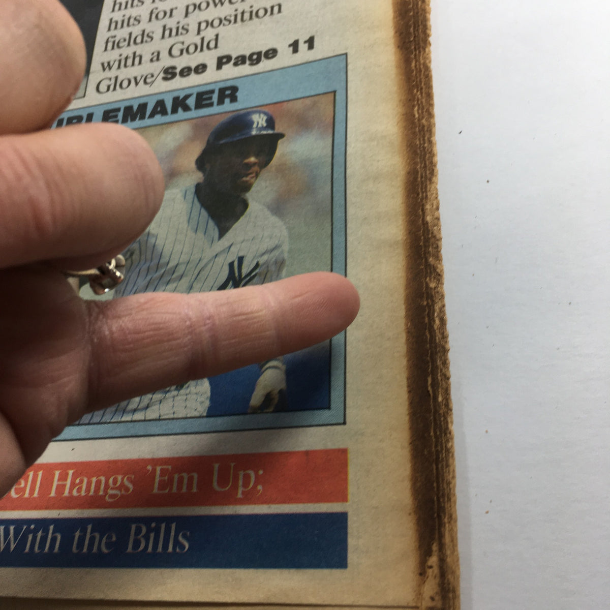 Close-up of The Sporting News September 1 1966 showing Rickey Henderson's image with a finger pointing at it, emphasizing the article about his impact in baseball.