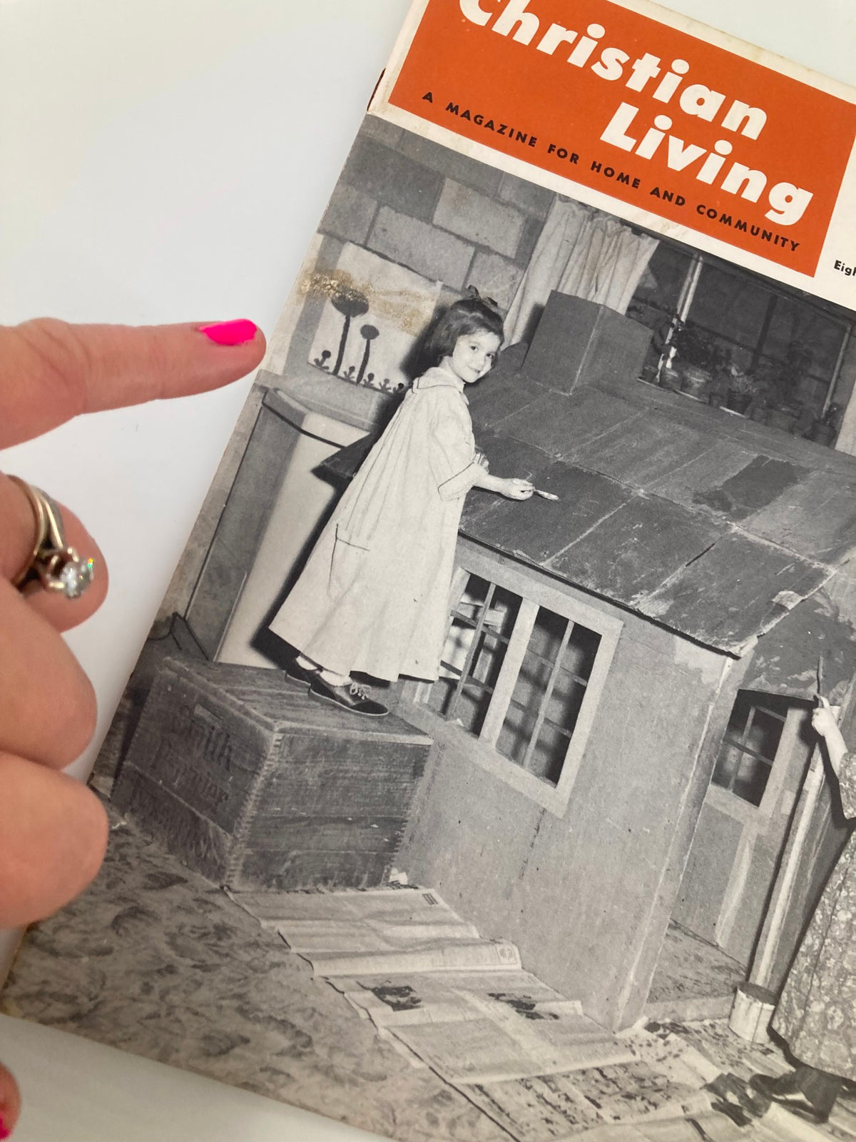 Vintage illustration from VTG Christian Living Magazine May 1961 showing a child painting a dollhouse, with the magazine's title visible.
