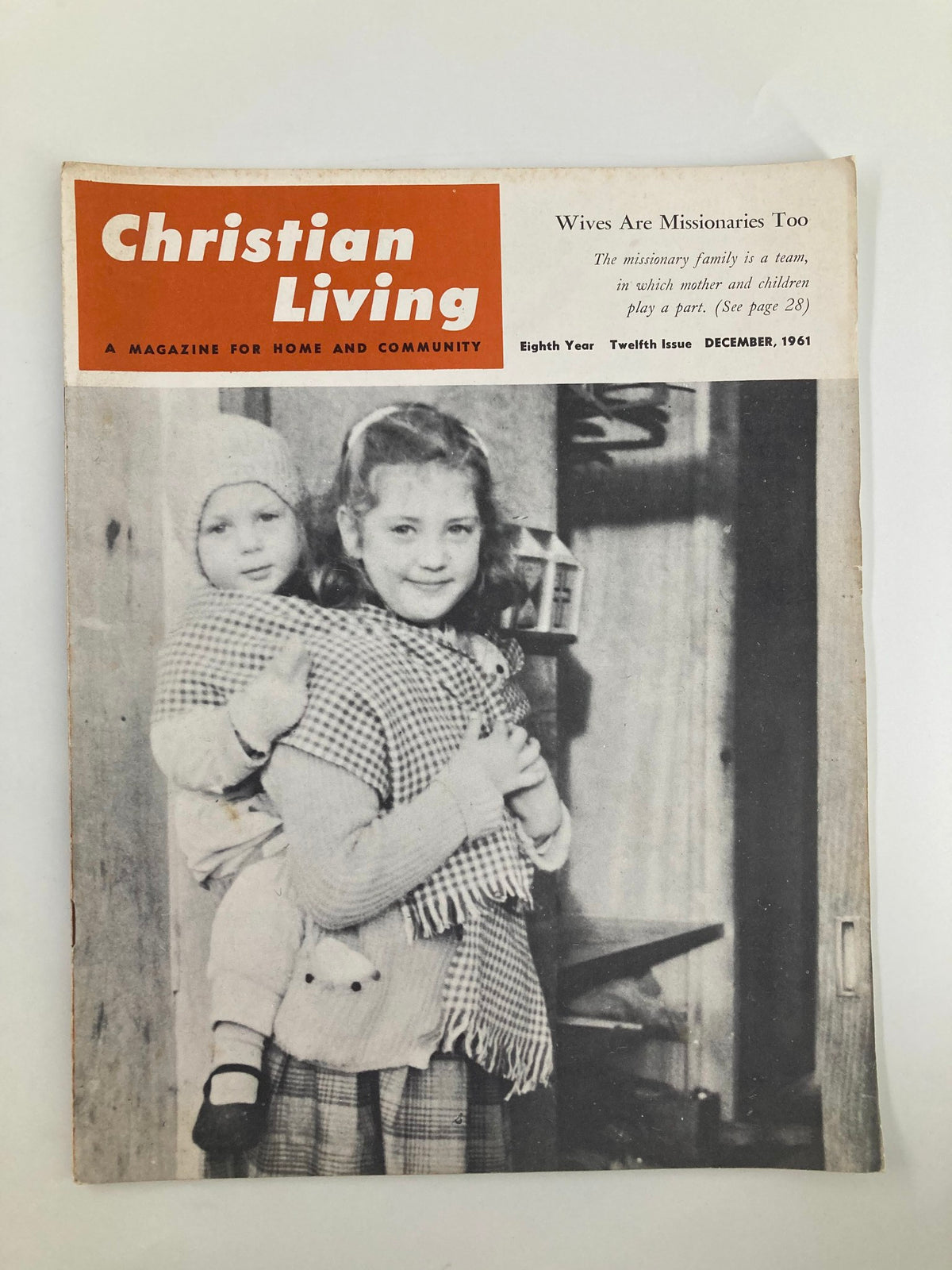 Cover of the December 1961 issue of Christian Living Magazine titled 'Wives Are Missionaries Too,' featuring two children, one wearing a hat and a scarf, the other being held, set against a vintage background.