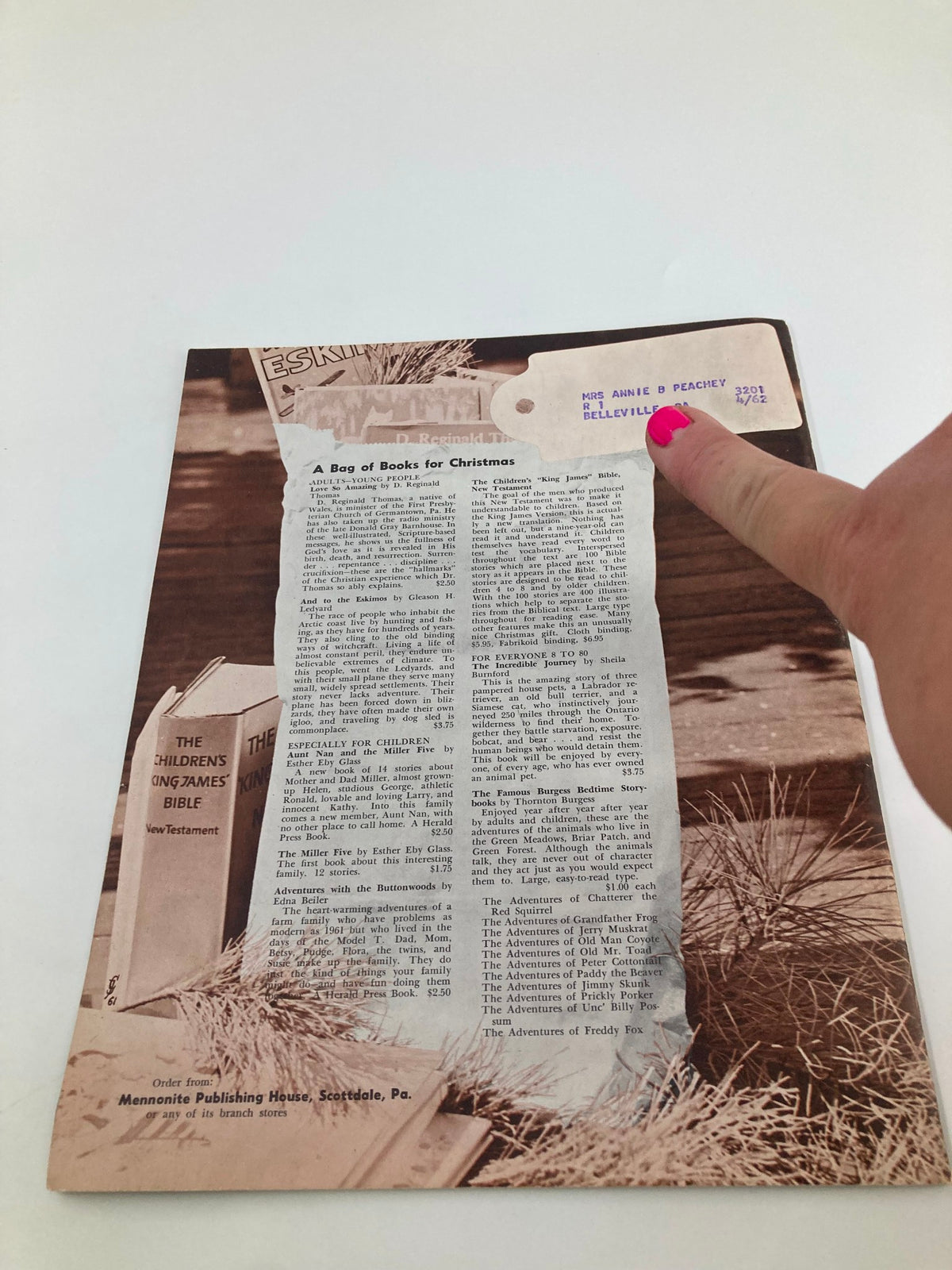 Back cover of the VTG Christian Living Magazine December 1961 titled 'Wives Are Missionaries Too,' featuring a Christmas-themed article titled 'A Bag of Books for Christmas' and a vintage label addressed to Mrs. Annie B. Peachey.
