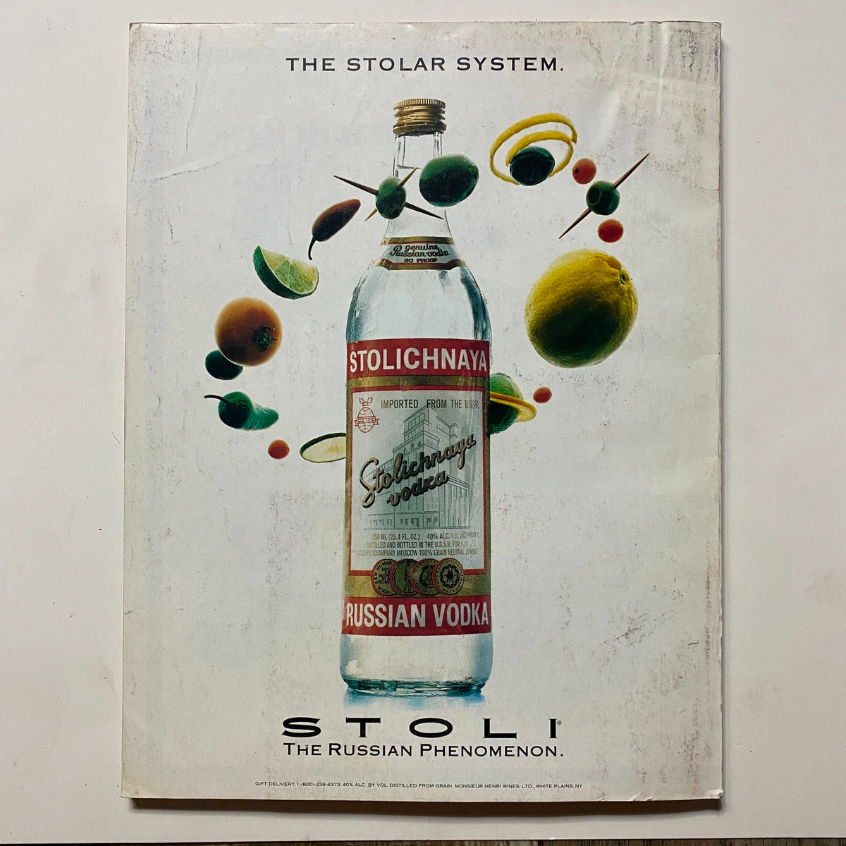 Omni Magazine October 1991 Vol 14 No. 1 The Whole Evolution Almanac featuring an advertisement for Stolichnaya Vodka with a creative design and vibrant imagery, illustrating fruits and planets, symbolizing the Russian phenomenon.