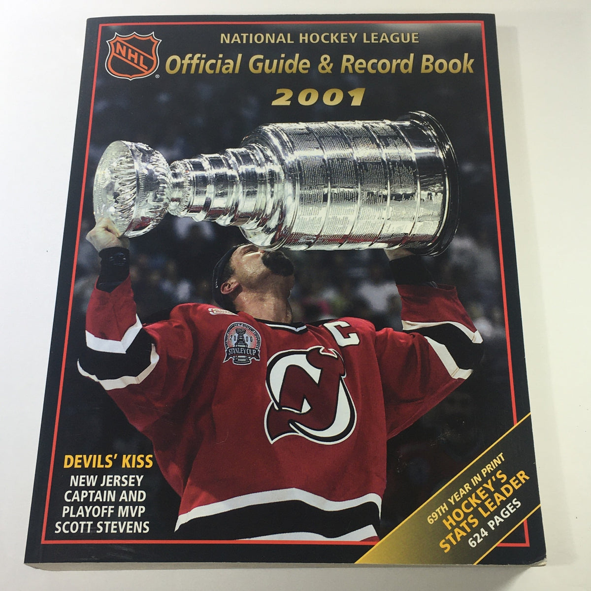 VTG NHL Official Guide & Record Book 2001 featuring Scott Stevens celebrating with the Stanley Cup, highlighting the New Jersey Devils captain's achievement.
