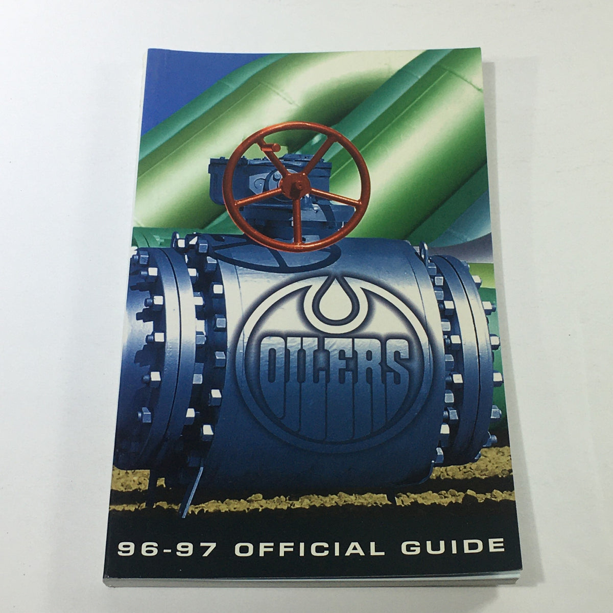 Cover of the VTG NHL Official Guide 1996-1997 featuring the Edmonton Oilers logo and an industrial design element.
