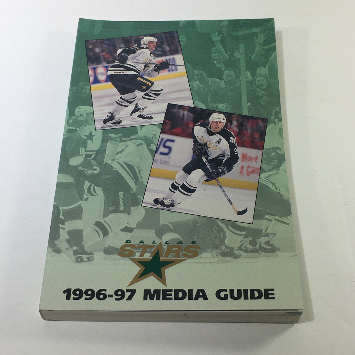 Vintage NHL Official Media Guide 1996-1997 featuring the Dallas Stars and Joe Nieuwendyk, showcasing cover artwork with player images and the team logo.