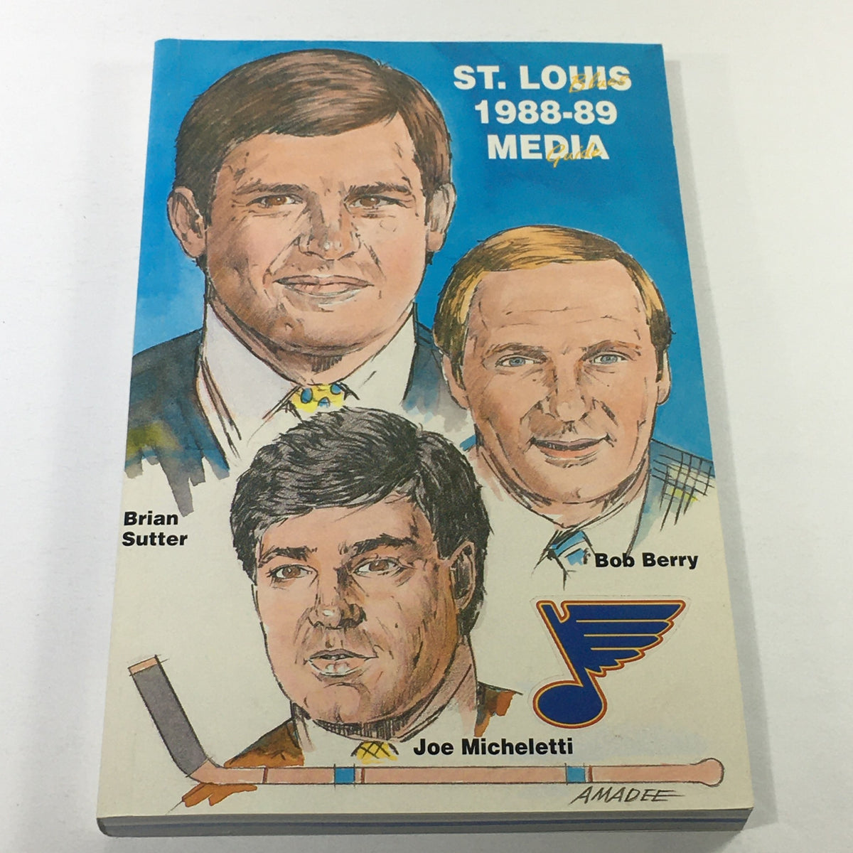 Cover illustration of the VTG NHL Official Media Guide 1988-1989 featuring St. Louis Blues players Brian Sutter, Bob Berry, and Joe Micheletti.