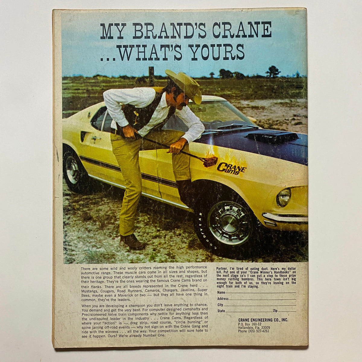 Back cover of Popular Hot Rodding Magazine October 1969, showing a vintage advertisement featuring a high-performance car alongside a cowboy, promoting Crane Engineering products.