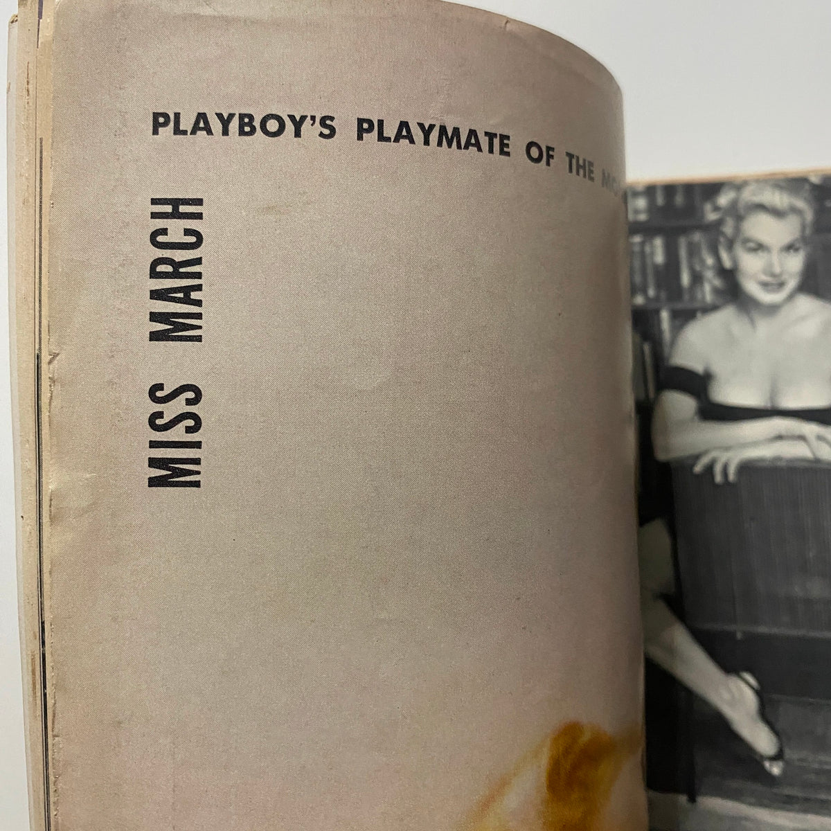 Close-up of the vintage Playboy magazine March 1956, showcasing the inside page featuring Marian Stafford as Miss March, highlighting its collectible aspect.