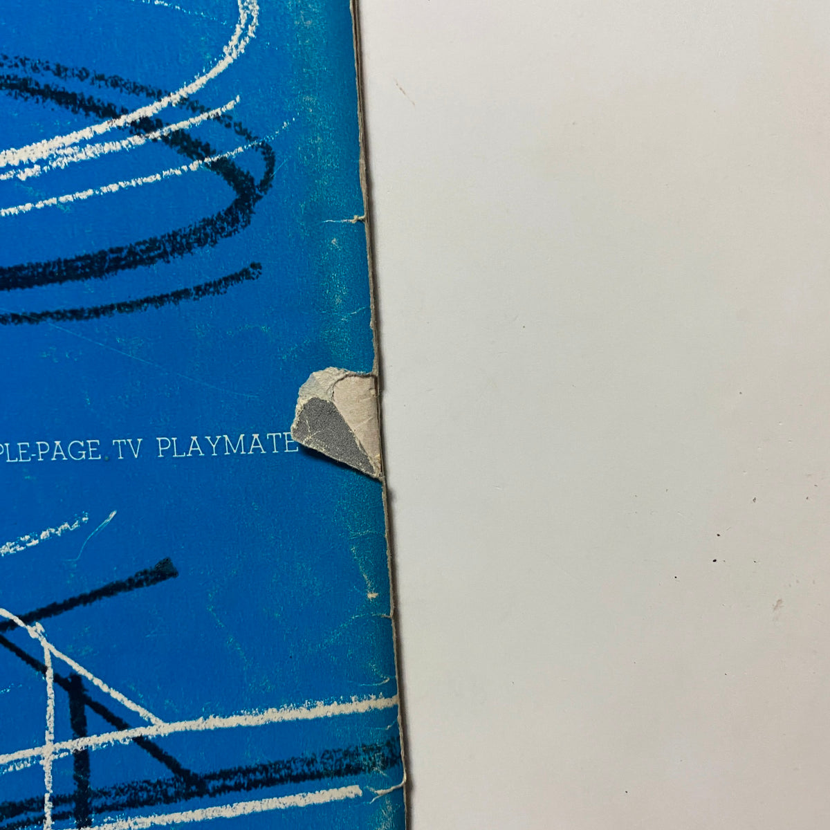 Detail of the back cover of the vintage Playboy magazine March 1956, highlighting the worn edge and original design elements related to Playboy's TV playmate feature.