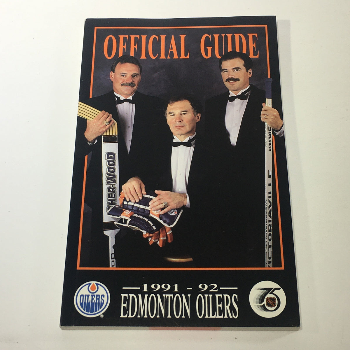 Lot of 5 VTG NHL Official Edmonton Oilers Guide 1991 - 1996, focusing on the cover of the 1991-92 guide, featuring players in formal attire and hockey gear.