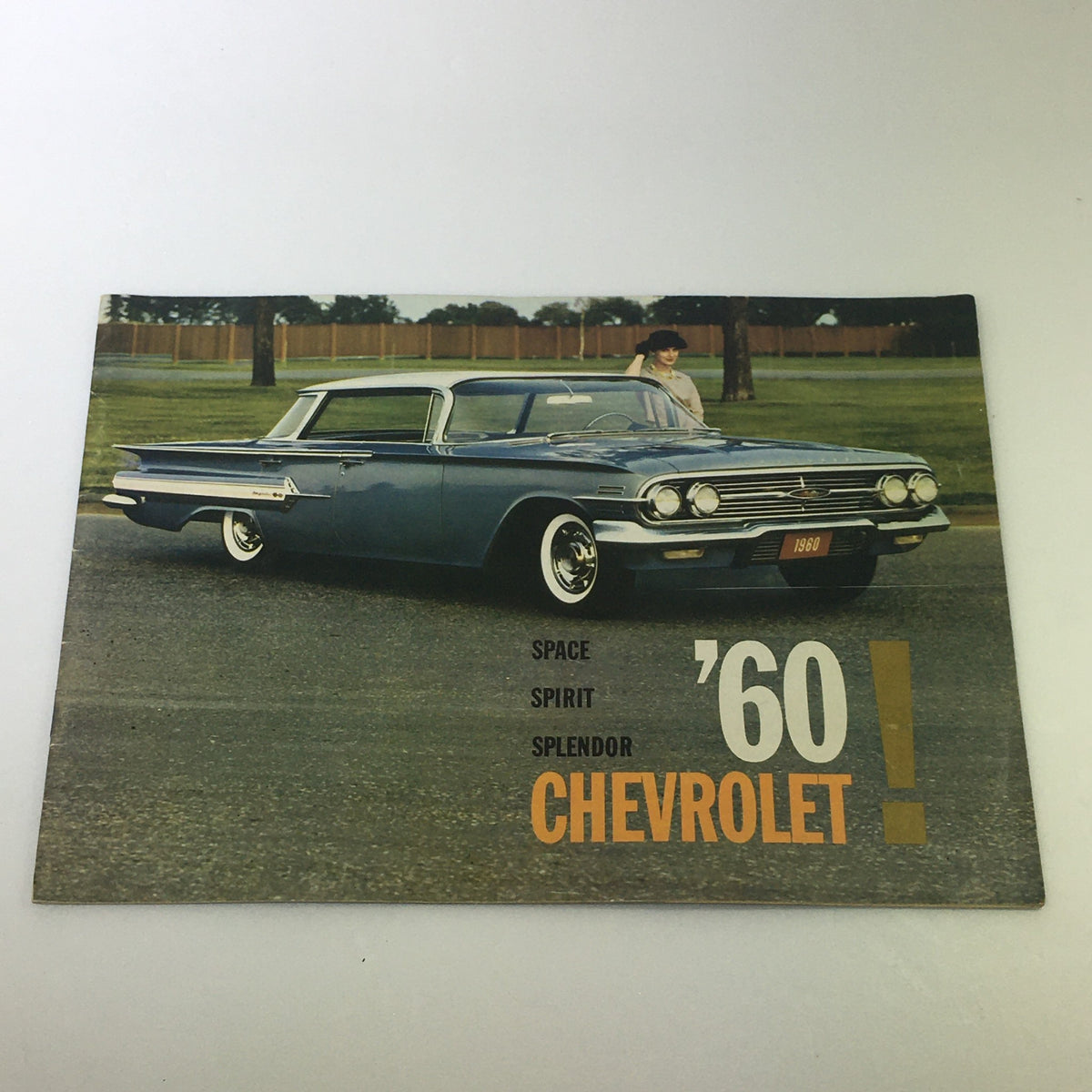 VTG 1960 Chevrolet Space Spirit Splendor Car Auto Brochure Cover featuring a sleek blue Chevrolet vehicle parked on a grassy area, showcasing classic 1960s automobile design.