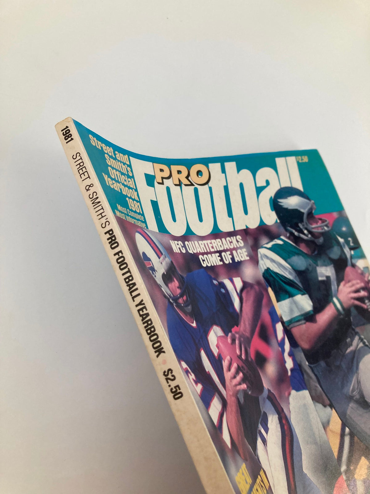 Cover of the VTG Pro Football 1981 Yearbook featuring quarterbacks with a bold title. This vintage magazine showcases iconic players Joe Ferguson and Ron Jaworski, highlighting the NFL's rich history.