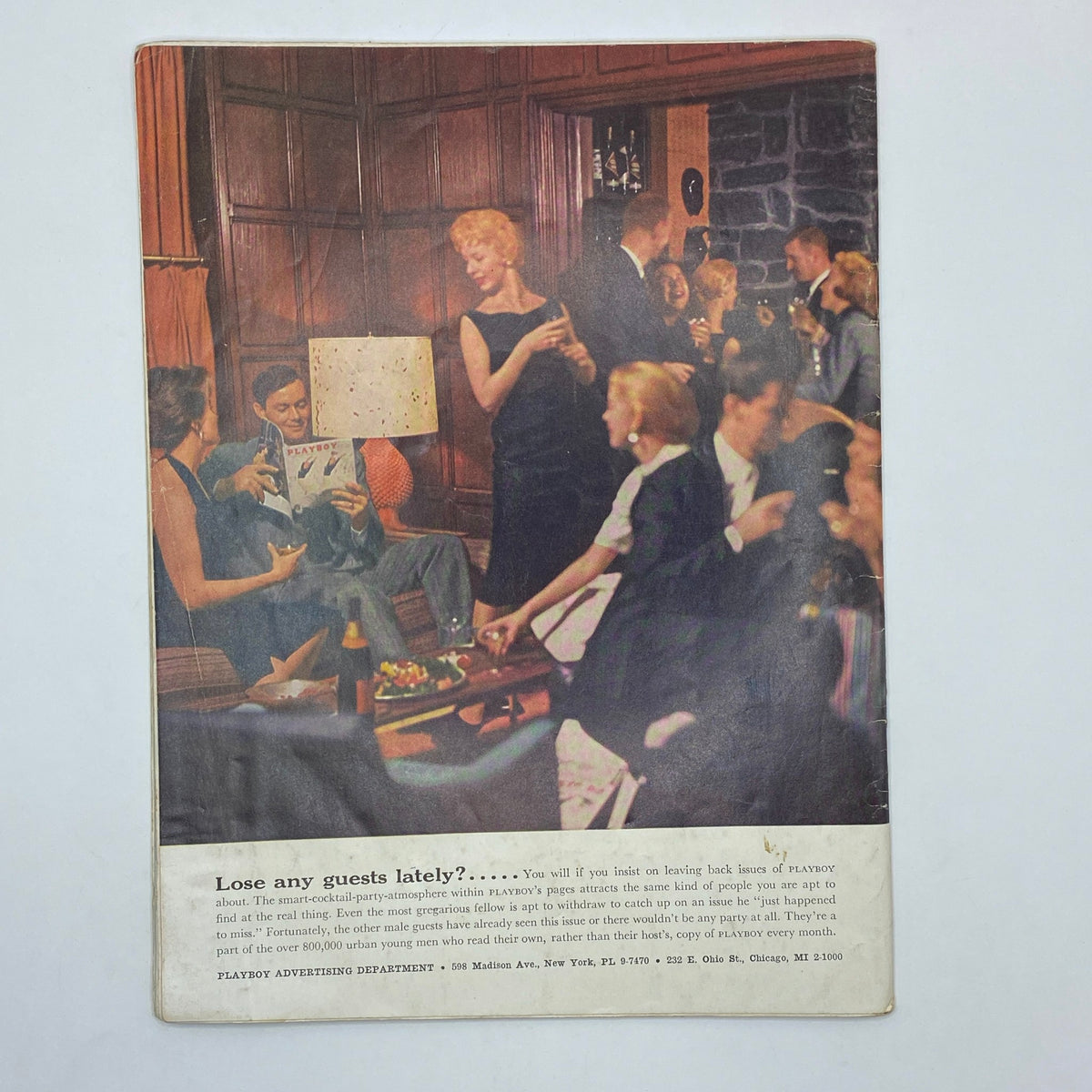Back cover of VTG Playboy Magazine July 1957 displaying a cocktail party scene with guests enjoying the classic Playboy experience.