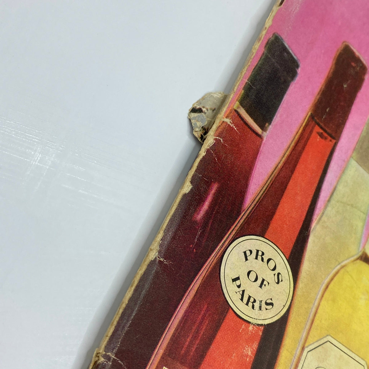 Close-up of the edge of the October 1958 Playboy Magazine featuring a colorful wine bottle advertisement. VTG Playboy Magazine October 1958 Playmate Mara Corday w Centerfold No Label.