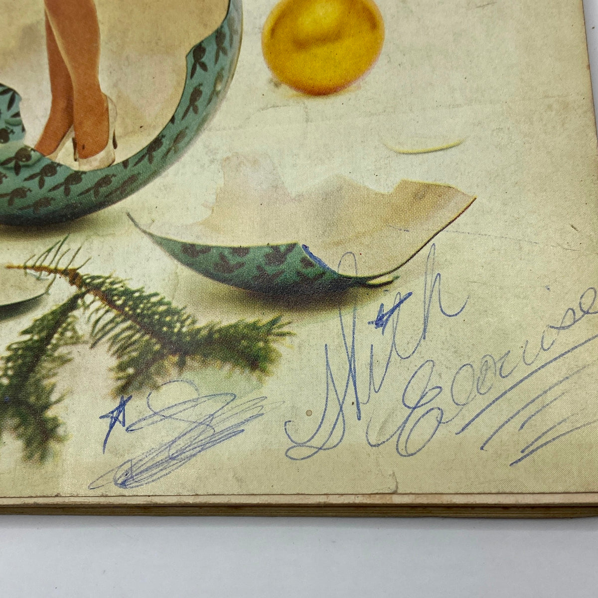 Detail from the cover of VTG Playboy Magazine December 1960, highlighting the signature and decorations around the central image.