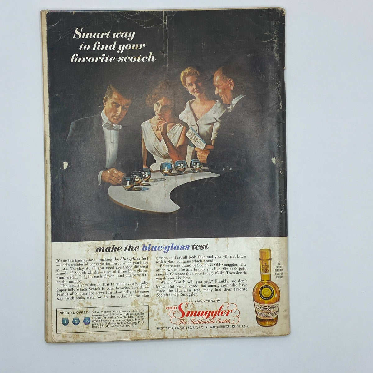 Back cover of VTG Playboy Magazine December 1960, displaying an advertisement for Smuggler Scotch with a classic social scene.